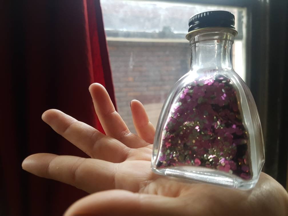 Eco-friendly glitter in glass bottle for burlesque pours, photoshoots, wedding toss, soap making, and bulk sparkles